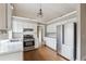Well-lit kitchen with stainless steel appliances and white cabinetry at 2006 Hawthorne Way, Woodstock, GA 30189