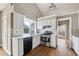 Well-lit kitchen features white cabinets, stainless steel appliances, and a large window at 2006 Hawthorne Way, Woodstock, GA 30189