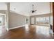 Open-concept living room with hardwood floors and a fireplace, filled with natural light at 2006 Hawthorne Way, Woodstock, GA 30189