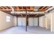 Unfinished basement garage with exposed ceiling, concrete floor, and a double garage door at 3585 Ale Cir, Atlanta, GA 30344