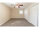 Cozy bedroom featuring neutral carpet, ceiling fan, and a closet for ample storage space at 3585 Ale Cir, Atlanta, GA 30344