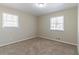 Bright bedroom featuring neutral carpet and large windows providing ample natural light at 3585 Ale Cir, Atlanta, GA 30344