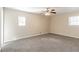 Bright bedroom featuring neutral carpet, a ceiling fan, and large windows providing ample natural light at 3585 Ale Cir, Atlanta, GA 30344
