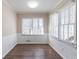 Sunny dining room with wainscoting, hardwood-style floors, and large windows at 3585 Ale Cir, Atlanta, GA 30344