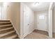 Inviting entryway with neutral paint, a front door with glass, and stairs leading to the upper level at 3585 Ale Cir, Atlanta, GA 30344