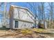 Back of a home featuring gray brick and siding, multi-level construction and a chimney at 3585 Ale Cir, Atlanta, GA 30344