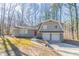 Charming split-level home featuring a two-car garage and a distinctive red front door at 3585 Ale Cir, Atlanta, GA 30344