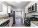 Well-lit kitchen with stainless steel appliances, granite countertops, and adjacent dining area at 3585 Ale Cir, Atlanta, GA 30344