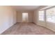 Bright living room with neutral paint and flooring, and a large bay window providing ample natural light at 3585 Ale Cir, Atlanta, GA 30344