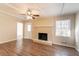 Comfortable living room featuring a brick fireplace, ceiling fan, and hardwood-style floors at 3585 Ale Cir, Atlanta, GA 30344