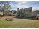 Large, grassy backyard featuring a deck, mature trees and partial fence at 4074 Gold Mill Rdg, Canton, GA 30114
