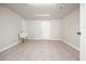 Unfinished basement space with concrete floors and walls, utility sink and access door at 4074 Gold Mill Rdg, Canton, GA 30114