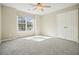Bright bedroom featuring neutral walls, gray carpet, ceiling fan, and natural light from a large window at 4074 Gold Mill Rdg, Canton, GA 30114
