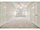 Spacious bedroom featuring tray ceilings, neutral walls, gray carpet, and double closets at 4074 Gold Mill Rdg, Canton, GA 30114