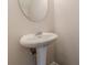 Bathroom showcasing pedestal sink and oval mirror at 1732 Broad River Rd, Atlanta, GA 30349