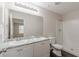 Bright bathroom featuring a double sink vanity with granite countertops and a shower with white tile at 1732 Broad River Rd, Atlanta, GA 30349