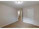Cozy bedroom with neutral walls, carpet, and a white door at 1732 Broad River Rd, Atlanta, GA 30349