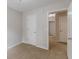 Cozy bedroom with neutral walls, carpet, and two white doors at 1732 Broad River Rd, Atlanta, GA 30349