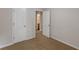 Cozy bedroom with neutral walls, carpet, and a white door at 1732 Broad River Rd, Atlanta, GA 30349