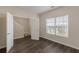 Bedroom features dark wood flooring, a window for natural light, and white doors at 1732 Broad River Rd, Atlanta, GA 30349