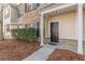 Inviting front entrance featuring a dark-stained front door and manicured landscaping at 1732 Broad River Rd, Atlanta, GA 30349