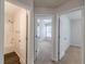 Hallway with access to the bathroom and two carpeted bedrooms at 1732 Broad River Rd, Atlanta, GA 30349