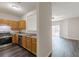 Kitchen with stainless steel appliances, wood cabinets, and open to the living room at 1732 Broad River Rd, Atlanta, GA 30349