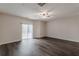 Living room featuring sliding glass doors for natural light and gray wood-look flooring at 1732 Broad River Rd, Atlanta, GA 30349