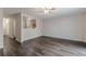 Spacious living room features modern gray wood-look flooring and a ceiling fan at 1732 Broad River Rd, Atlanta, GA 30349