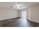 Living room with ceiling fan, lots of natural light, and dark wood flooring at 1732 Broad River Rd, Atlanta, GA 30349