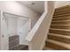 Carpeted staircase with white handrail leading to the upper level at 1732 Broad River Rd, Atlanta, GA 30349