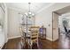 Charming dining room featuring a small dining table, a chandelier, and hardwood floors at 3777 Peachtree Ne Rd # 911, Atlanta, GA 30319