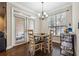 Charming dining area with modern chandelier, access to the balcony, and hardwood floors at 3777 Peachtree Ne Rd # 911, Atlanta, GA 30319