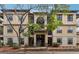 Inviting multi-story condo with a manicured lawn, trees, and traditional architectural features at 3777 Peachtree Ne Rd # 911, Atlanta, GA 30319