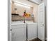 Functional laundry room with washer, dryer, shelving and white door for a clean and organized space at 3777 Peachtree Ne Rd # 911, Atlanta, GA 30319