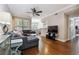 Cozy living room with dark hardwood floors, a comfortable gray sofa, and bright windows at 3777 Peachtree Ne Rd # 911, Atlanta, GA 30319