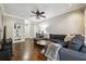 Inviting living room featuring hardwood floors, large sectional sofa, and a view of built in shelves at 3777 Peachtree Ne Rd # 911, Atlanta, GA 30319