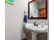 Powder room with a pedestal sink and a large mirror, creating a simple and functional space at 3777 Peachtree Ne Rd # 911, Atlanta, GA 30319