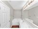 Bright bathroom with a large vanity, soaking tub, and a modern light fixture illuminating the space at 745 Crestwell Sw Cir, Atlanta, GA 30331