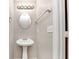 Bathroom features a pedestal sink, framed oval mirror, and modern lighting fixture at 745 Crestwell Sw Cir, Atlanta, GA 30331