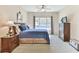 Relaxing bedroom with neutral decor, including two nightstands, a ceiling fan, and a dark wood dresser at 2817 Middlecreek Way # 1703, Cumming, GA 30041