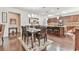 Open-concept dining area with a large table, hardwood floors, and a view of the kitchen at 2817 Middlecreek Way # 1703, Cumming, GA 30041
