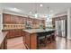 Gourmet kitchen with a large island, granite countertops, stainless appliances, and hardwood floors at 2817 Middlecreek Way # 1703, Cumming, GA 30041