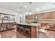 Well-appointed kitchen with a large island, dark wood cabinets, and stainless steel appliances at 2817 Middlecreek Way # 1703, Cumming, GA 30041
