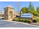 Wellstone community entrance with stone signage surrounded by manicured landscaping on a sunny day at 2817 Middlecreek Way # 1703, Cumming, GA 30041