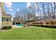Well-maintained backyard featuring a lush lawn, inground pool, and secluded patio area at 2952 Perimeter Cir, Buford, GA 30519