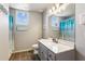 Cozy bathroom with a single sink vanity, framed mirror and tub with curtain at 2952 Perimeter Cir, Buford, GA 30519