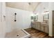 Bathroom featuring dual vanities, granite countertop, stand-up shower, and wood flooring at 2952 Perimeter Cir, Buford, GA 30519