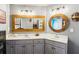 Unique double vanity bathroom with decorative mirrors and plenty of lighting at 2952 Perimeter Cir, Buford, GA 30519