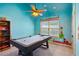 Bright bedroom features a pool table, ceiling fan, and whimsical Mario-themed wall decor at 2952 Perimeter Cir, Buford, GA 30519